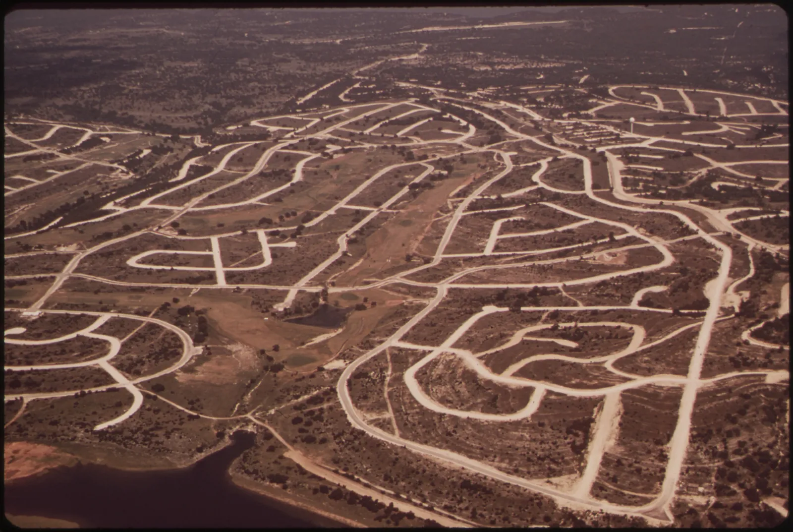 Streets cut into the hills before the houses came. Lake Travis, May 1972