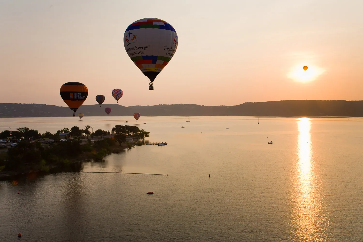 Hot air balloons at sunrise over Lake Travis
